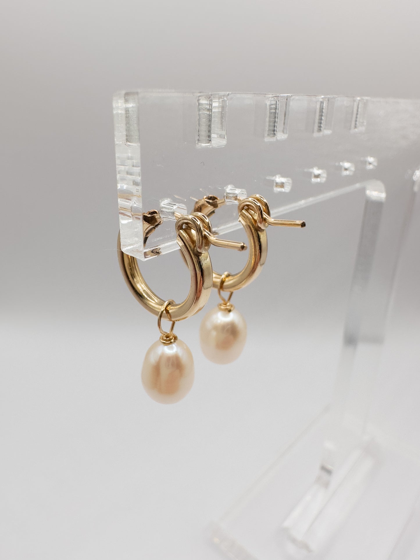 OS gold filled & pearl huggie hoop earrings.